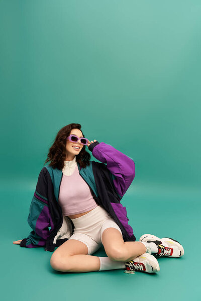 A confident young woman poses in a trendy sporty outfit, showcasing her unique style and flair.