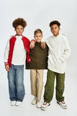 Three cute boys show off their unique styles in vibrant outfits, enjoying their friendship.