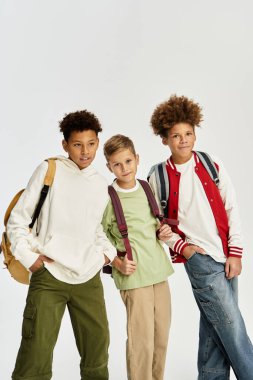 Three cute boys in bright outfits showcase their unique styles and friendship.