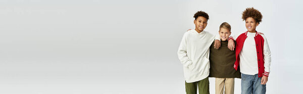 Adorable little boys sport vibrant outfits while enjoying their friendship in a cheerful moment.