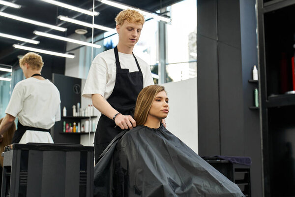 A stylist works on a clients hair, highlighting trendy styles in a chic salon.