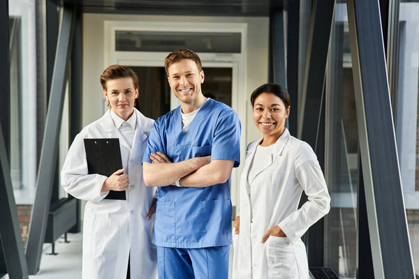 Three multicultural doctors team up in a modern hospital, working together for health.