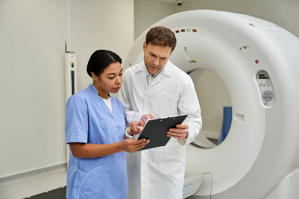 Two doctors in white coats discuss an MRI scan, ensuring accurate patient diagnosis in healthcare.