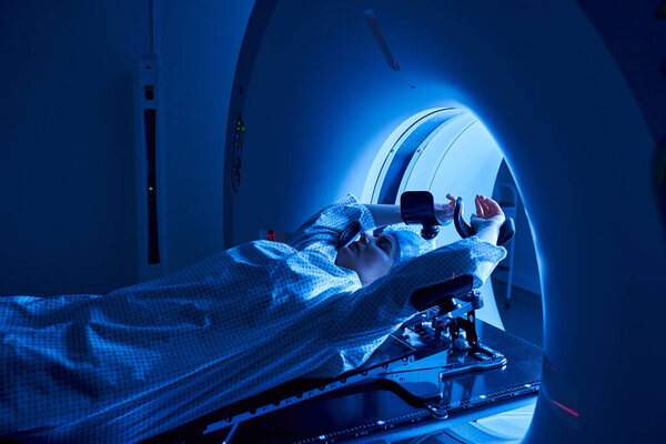 A woman undergoes MRI scanning in a cutting-edge hospital environment, focusing on health.