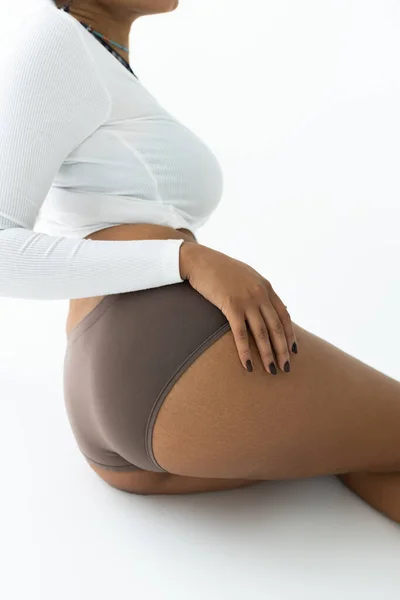 Cropped view of african american woman posing in long sleeve shirt and panties isolated on white — Stock Photo