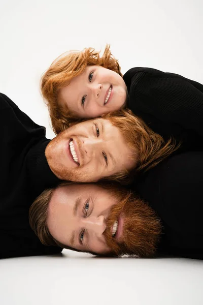 Cheerful redhead men and boy in black sweaters having fun while posing on light grey background — Stock Photo
