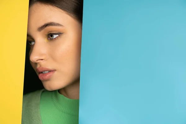 Portrait of brunette teenager looking away on colorful background with copy space — Stock Photo