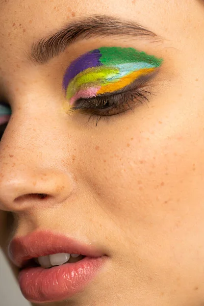 Close up view of freckled teenage model with colorful eyeshadows — Stock Photo