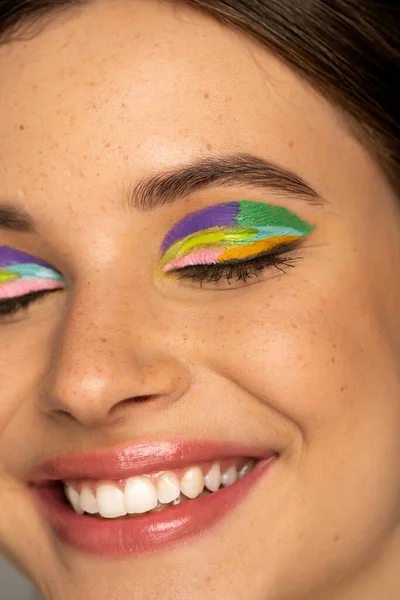 Close up view of happy teen girl with creative makeup closing eyes — Stock Photo