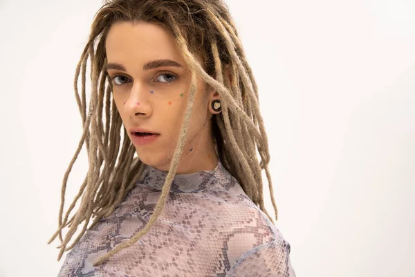 Portrait of tattooed queer person with dreadlocks hairstyle isolated on white — Stock Photo