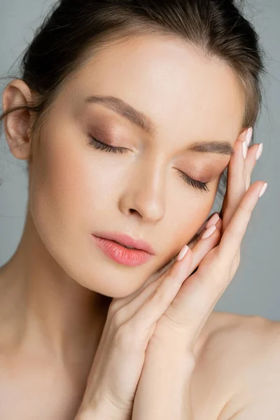 Portrait of young fair haired model with perfect skin posing isolated on grey — Stock Photo