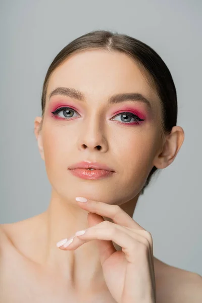 Portrait of fair haired woman with pink visage looking at camera isolated on grey — Fotografia de Stock