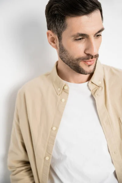Portrait of brunette man in casual clothes looking away on white background — Foto stock
