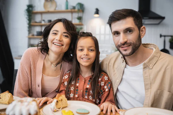 Positive family looking at camera during Easter dinner at home — Fotografia de Stock