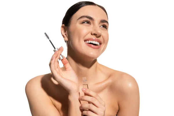 Happy brunette woman holding eyebrow brush and styling gel isolated on white — Stock Photo