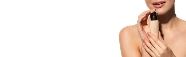 Cropped view of young woman holding bottle with liquid makeup foundation isolated on white, banner — Stock Photo
