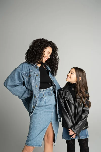 Smiling mother and daughter looking at each other isolated on grey — Stock Photo