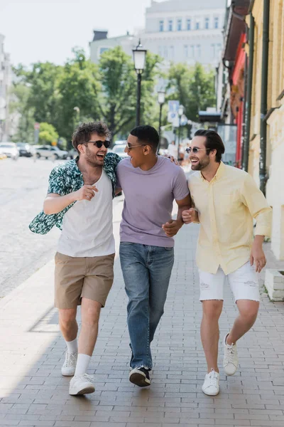 Позитивні міжрасові друзі спілкуються під час прогулянок по андроїдам, що спускаються в Києві. — стокове фото