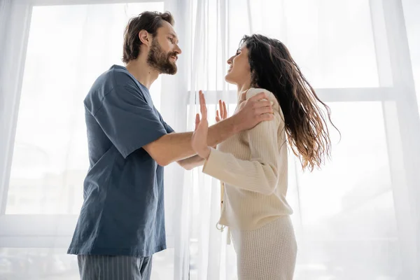Side view of angry woman quarreling with boyfriend at home — Stock Photo