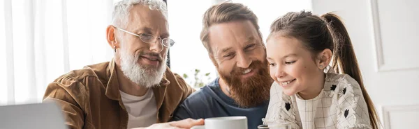 Overjoyed homosexual parents spending time with daughter at home, banner — Stock Photo