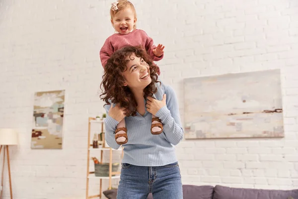Quality time, happiness, work and life harmony, cheerful woman with excited baby girl on shoulders, balanced lifestyle, mom daughter time, having fun together, loving motherhood — Stock Photo