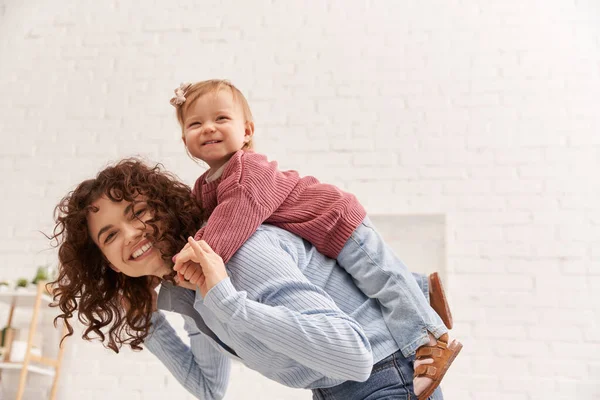 Quality time, happiness, work and life harmony, cheerful woman with excited baby girl on back, balanced lifestyle, mom daughter time, having fun together, bonding, loving motherhood — Stock Photo