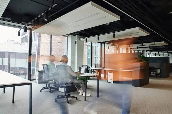 Bewegungsunschärfe von Menschen, die in der Nähe von Geschäftsleuten arbeiten, die im Großraumbüro mit High-Tech-Interieur, dynamischem Geschäfts- und Produktivitätskonzept arbeiten — Stockfoto