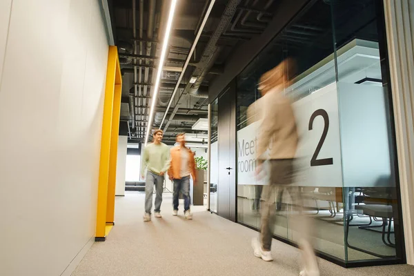 Motion blur of modern business people working in corridor along meeting room in contemporary coworking environment with high tech interior, dynamic business concept — Stock Photo