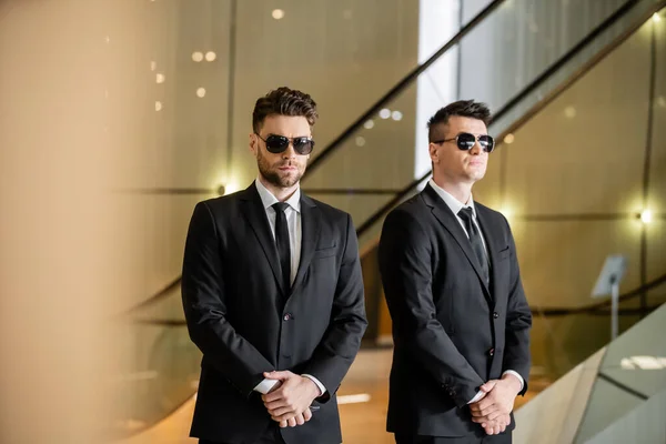 Security management of luxury hotel, two handsome men in formal wear and sunglasses, guards on duty, safety measures, vigilance, suits and ties, private security, strong bodyguards — Stock Photo