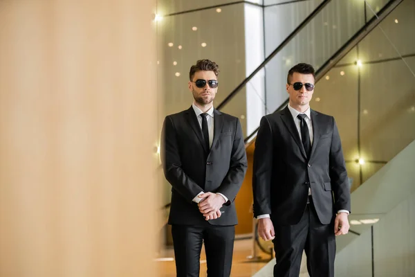 Security guards, two handsome men in formal wear and sunglasses, bodyguards on duty, safety measures, vigilance, black suits and ties, private security, strong men — Stock Photo
