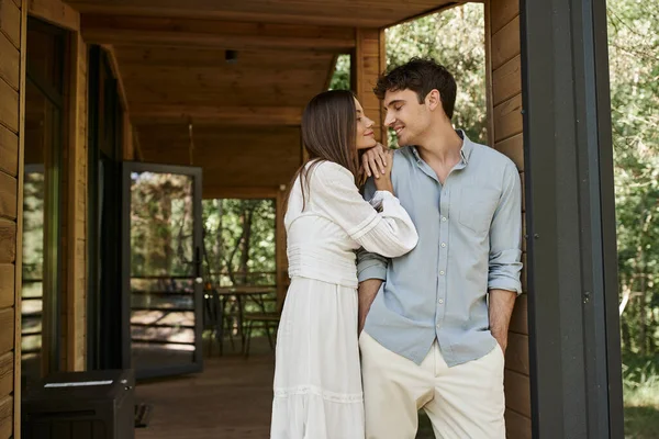 Schöner Mann und schöne Frau stehen in der Nähe von Ferienhaus, Liebe und Romantik, glückliches Paar — Stockfoto