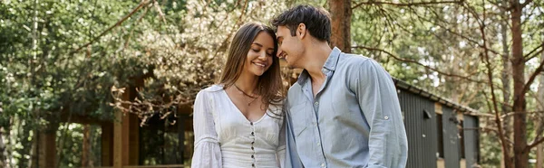 Banner, happy woman and man, joyful couple smiling near vacation house in forest, nature and people — Stock Photo