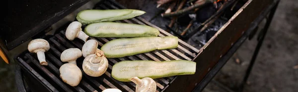 High angle view of zucchini and mushrooms on barbecue during picnic outdoors, banner, — Stock Photo
