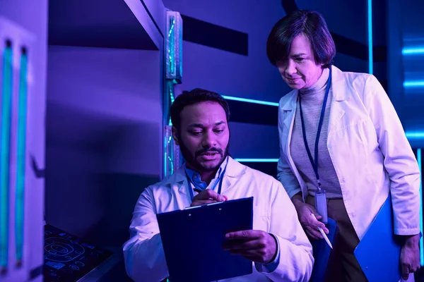 Hindu Male and Adult Female Scientists Analyze Data in Neon-Lit Science Center — Stock Photo