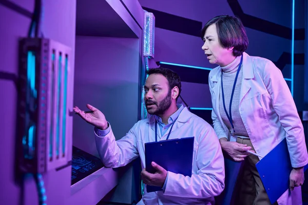 Hindu Male and Adult Female Scientists Engage with Computer in Neon-Lit Science Center — Stock Photo