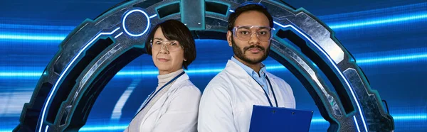 Multiethnic scientists looking at camera near experimental device in science center, banner — Stock Photo
