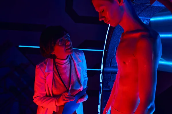 Conceito futurista, mulher cientista falando com extraterrestre humanóide no centro de ciências — Fotografia de Stock