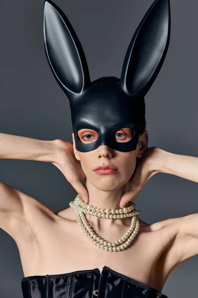 Queer person in corset and black bdsm bunny mask on grey, pearl necklace, lgbtq, androgynous — Stock Photo