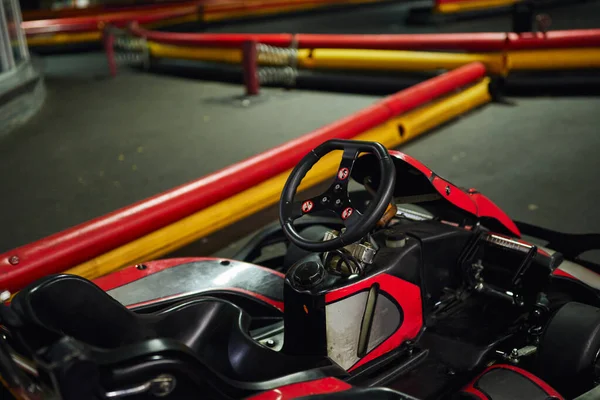 Design of red racing car inside of indoor kart circuit, motor race vehicle, go cart, steering wheel — Stock Photo