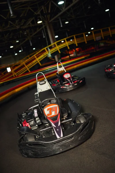 Modern racing cars inside of indoor circuit, motor race vehicles, go kart for speed racing — Stock Photo
