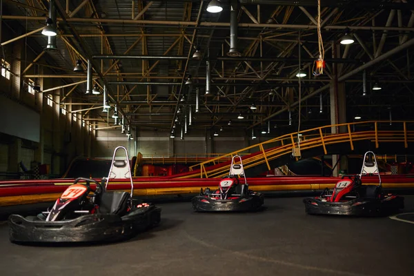 Modern racing cars inside of indoor kart circuit, motor race sport vehicles, speed racing karting — Stock Photo