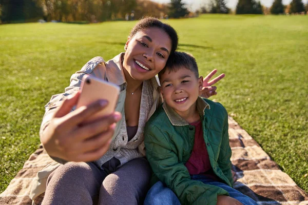 Liens, heureux afro-américaine mère prendre selfie avec fils, femme et garçon, automne, signe v — Photo de stock