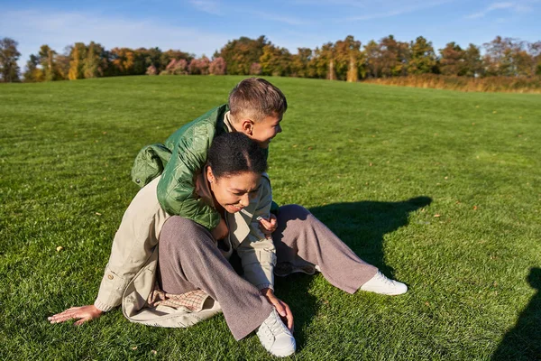 Happy mother and son in park, sunny day, autumn, african american family, diversity, boy hugging mom — Stock Photo