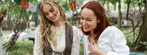 Laughing women in stylish outfits spending time together in retreat center outdoors, banner — Stock Photo