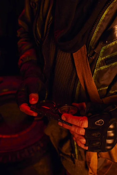 Cropped view of man in fingerless gloves holding pressure gauge of abandoned subway carriage — Stock Photo