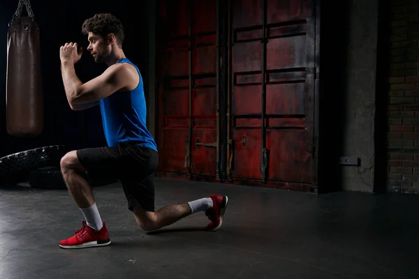 Full length of athletic man in sportswear working out on dark city street at night, side view — Stock Photo