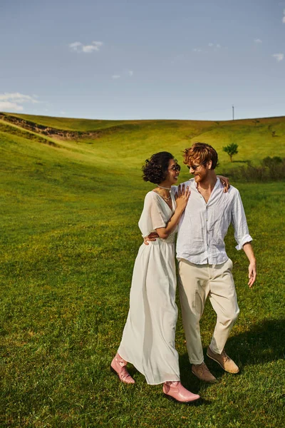 Just married couple, asian bride in white dress walking with groom in field, countryside nature — Stock Photo