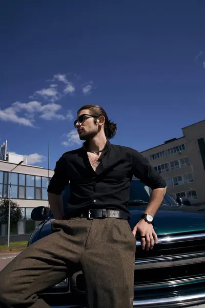 Vertical shot of stylish sexy man with sunglasses and wristwatch posing near car and looking away — Stock Photo