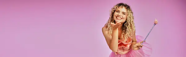 Pretty joyful woman in tooth fairy costume with magic wand in hand sending kiss at camera, banner — Stock Photo