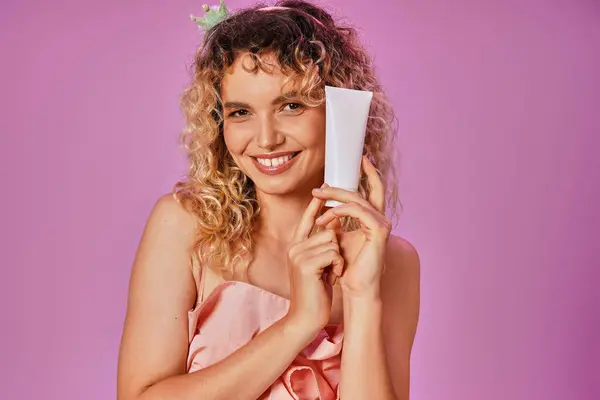 Happy blonde woman with curly hair in tooth fairy costume and headband holding tooth paste — Stock Photo
